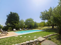 Wooden deck and swimming pool nestled in a lush garden at Domaine des Périès boutique B&B