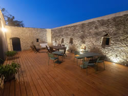 Evening atmosphere on the illuminated terrace with historic stone walls in Southern France