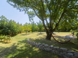 Peaceful relaxation corner with a hammock and dry stone wall in the Aude countryside