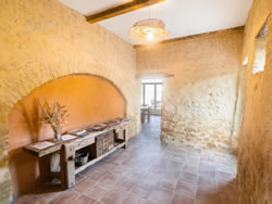 Authentic interior hallway with exposed stone walls and traditional terracotta tiles