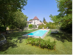 View of the swimming pool with the restored heritage farmhouse in the background